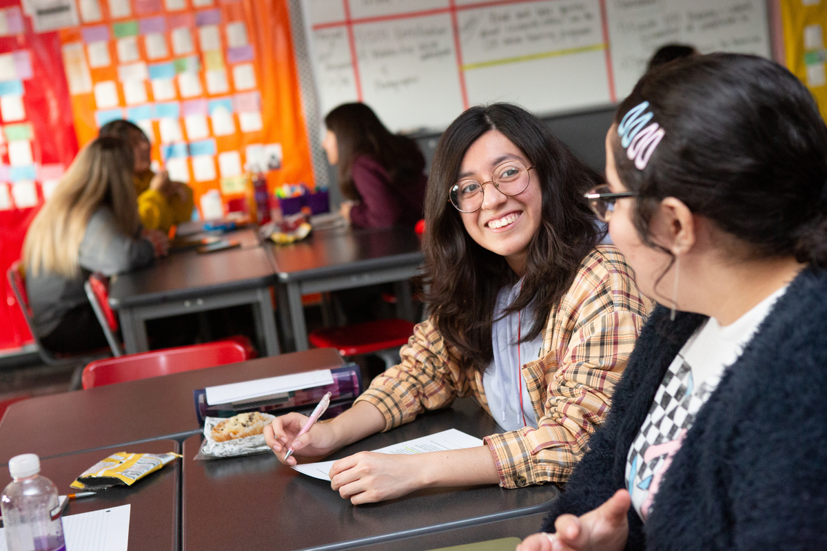 Photo of a high school student smiling in class