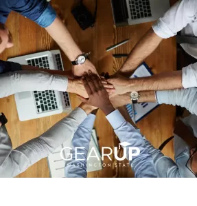 Team photo with hands in the middle.